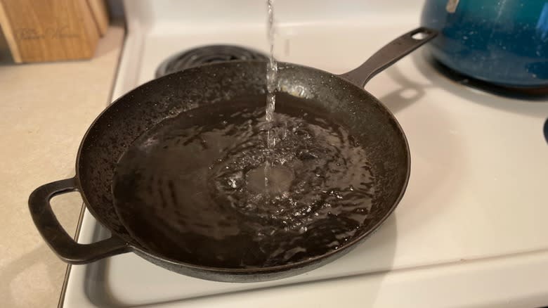 pouring water in skillet