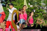 The cast of the MMFF 2012 entry "Sosy Problems", Solenn Heusaff, Heart Evangelista, Bianca King and Rhian Ramos are seen as their float makes its way at the 2012 Metro Manila Film Festival Parade of Stars on 23 December 2012.(Angela Galia/NPPA Images)