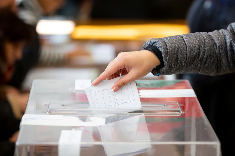 A vote being cast in a ballot box