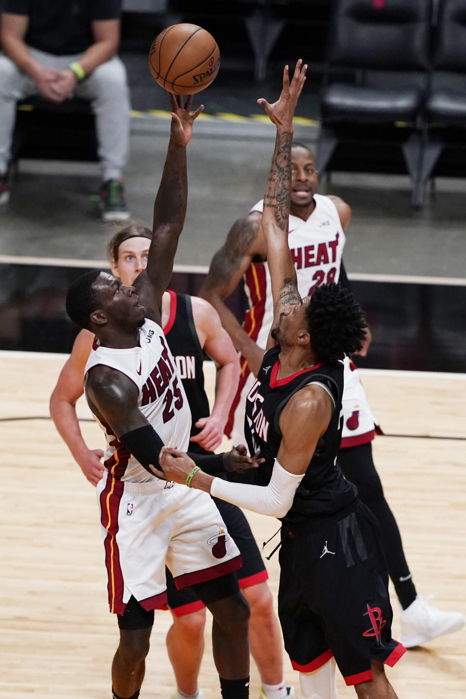 Miami Heat guard Kendrick Nunn (25) drives to the basket as Houston Rockets center Christian Wood defends, during the second half of an NBA basketball game, Monday, April 19, 2021, in Miami. (AP Photo/Marta Lavandier)