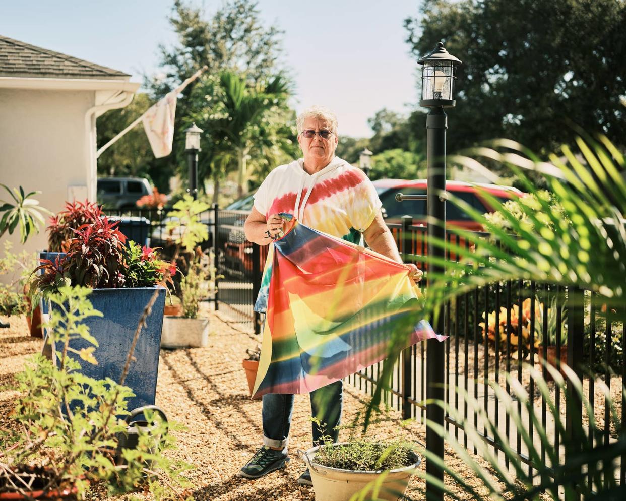 Booker High School teacher Gail Foreman holds a rainbow cape, which was given to her by a student, on Sept. 19, 2022, in Sarasota, Florida.