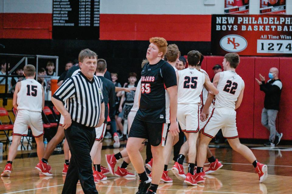 Tusky Valley's Caleb Weiland walks back to his bench in dismay after New Phila's Carter Vandall hit a one-handed three point shot from beyond center court at the half-time buzzer.