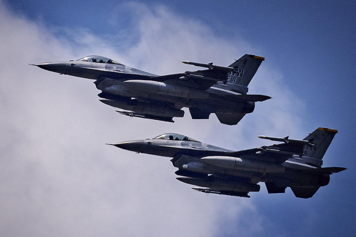 Two United States Air Force F-16 fighter jets fly in formation.