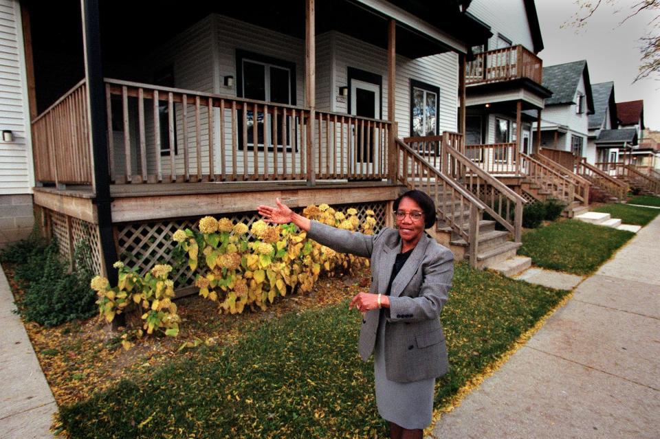 Cordelia Taylor, the CEO of Family House Inc., proudly points to one of seven homes that are part of the Family House in the 3300 block of North 11th Street in Milwaukee in this 1998 photo. Taylor received an award that year for being one of the 10 most caring men and women in America.