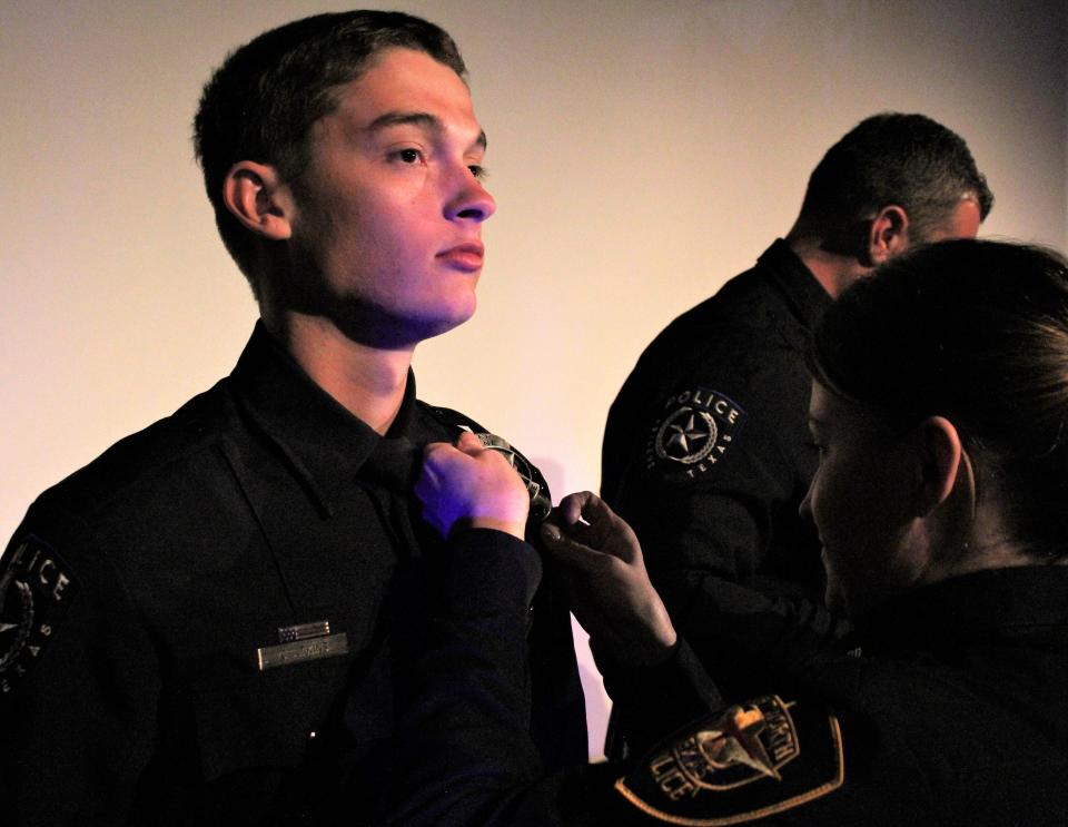 Cameron Adkins is pinned with his badge as a new member of the Abilene Police Department during the Class 60 graduation ceremony Thursday at the Paramount Theatre. March 2 2023