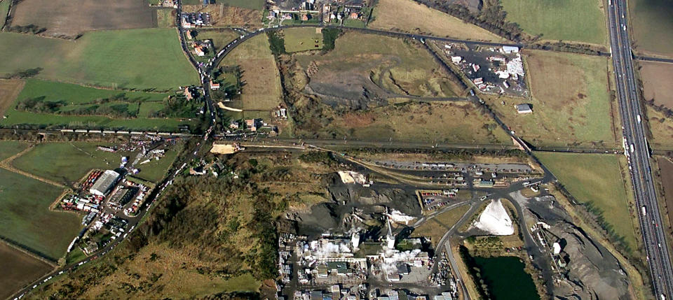 The scene at Great Heck, near Selby in North Yorkshire, where 13 people died in a road and rail accident. The crash occurred when a Land Rover left the M62 near where it crosses the East Coast main line (pictured right).   * The car was then in collision with the GNER express train which in turn collided with a freight train carrying more than 1,000 tonnes of coal, with many carriages coming to rest in a field. The remains of the two trains, which narrowly missed a number of houses in Great Heck, can be seen at the left of the picture.   (Photo by Phil Noble - PA Images/PA Images via Getty Images)