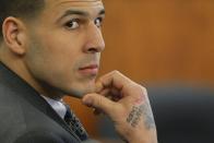 Former New England Patriots football player Aaron Hernandez listens as prosecution witness Alexander Bradley testifies at Bristol County Superior Court in Fall River, Massachusetts April 1, 2015. Bradley, a former friend of Hernandez, testified on Wednesday that he saw the ex-New England Patriots player handle a gun similar to the one prosecutors contend he used to murder an acquaintance, and that Hernandez had a distrustful nature. Hernandez, 25, is charged with killing Odin Lloyd, who was dating his fiancee's sister. REUTERS/Brian Snyder