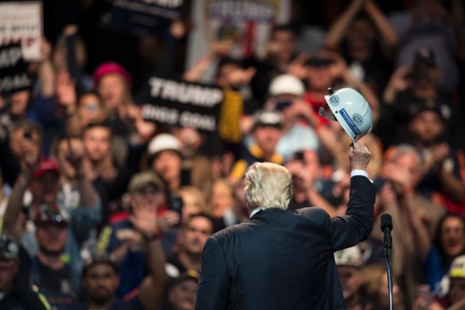 Donald Trump holds a miner’s helmet up after speaking during a rally in Charleston, West Virginia, in May 2016.