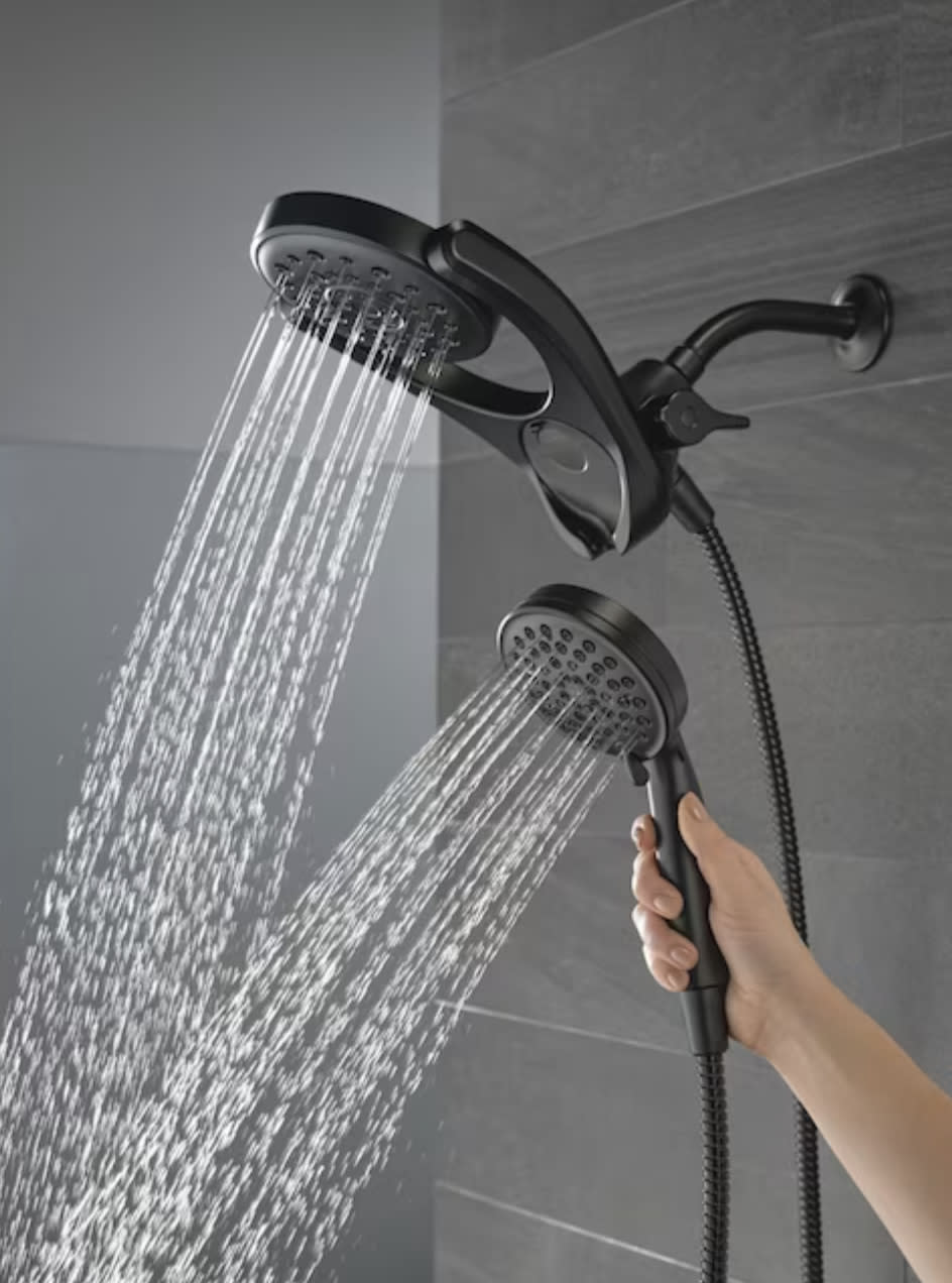 both shower heads running with model holding hand shower.