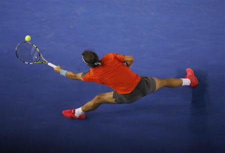 Rafael Nadal of Spain hits a return to Stanislas Wawrinka of Switzerland during their men's singles final match at the Australian Open 2014 tennis tournament in Melbourne January 26, 2014. REUTERS/David Gray