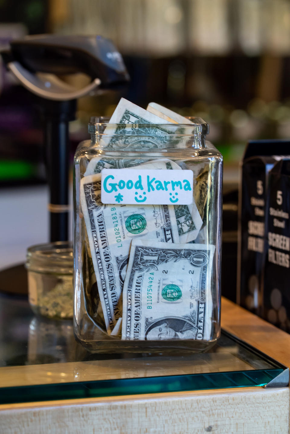 A tip jar that says, "good karma"