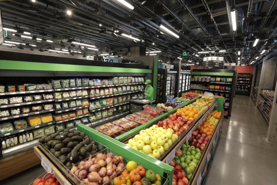 A worker checks the stock in the Amazon Go Grocery store in Seattle.