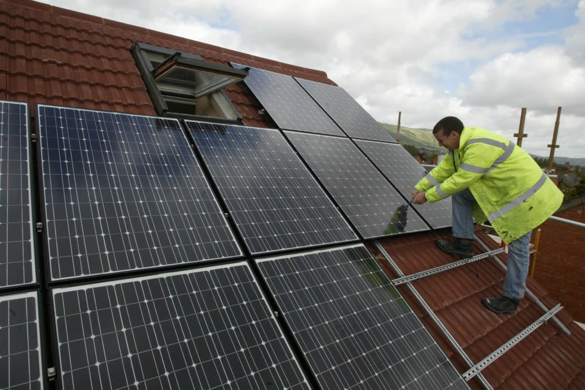 Community energy schemes can include the installation of solar panels and heat pumps on community buildings (PA Archive)