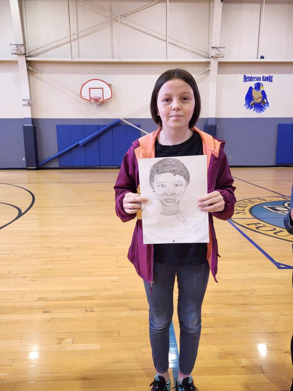 Boys & Girls Club of Springfield member Abby Henderson poses for a photo with her pencil drawing of Mae Jemsion. Cheek won second place in the sixth annual Boys and Girls Club of Springfield and UScellular Black History Month Art Contest. She received $150 for her second place drawing.