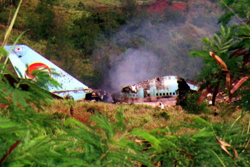 Wreckage of Korean Air Flight 801 still smolders August 6, 1997, after crashing on the island of Guam. The crash killed 228 people. File Photo by Troy R. Wegleitner/Department of Defense