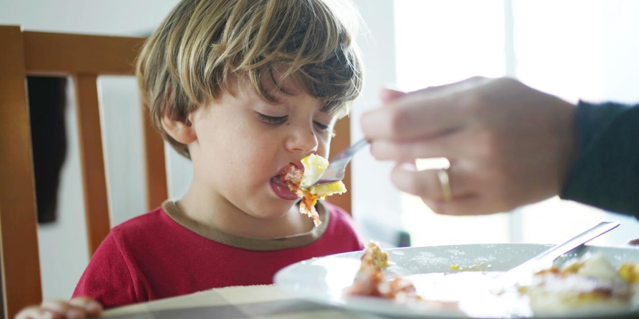 toddler boy rejecting fork of food