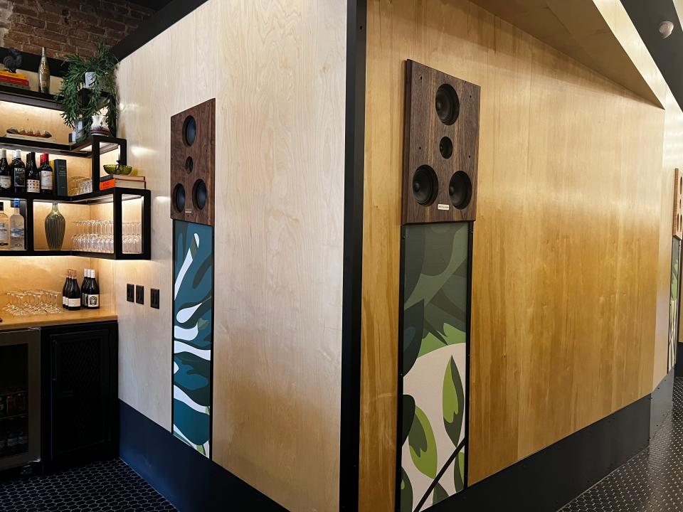 Speakers built into the walls have artwork painted below.