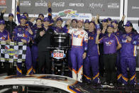 Denny Hamlin, center, celebrates with crew members after winning the NASCAR Daytona 500 auto race at Daytona International Speedway, Monday, Feb. 17, 2020, in Daytona Beach, Fla. (AP Photo/Terry Renna)