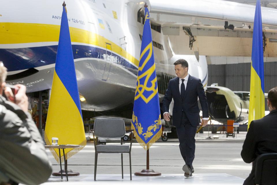 Ukrainian President Volodymyr Zelenskyy arrives to attend a news conference with the world's largest airplane, Ukrainian Antonov An-225 Mriya in the background, at the Antonov aircraft factory in Kyiv, Ukraine, Thursday, May 20, 2021. (AP Photo/Efrem Lukatsky)