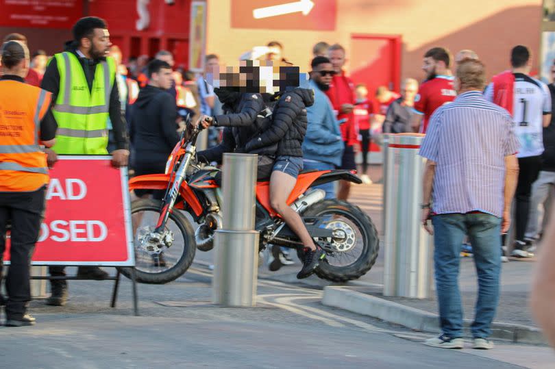 Scrambler bike riders weave in between Anfield crowd