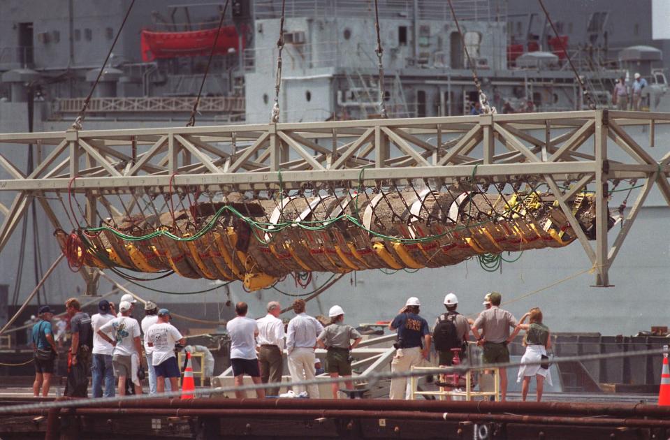 FILE - The Confederate submarine H.L. Hunley is raised from a barge by a crane at the former Charleston Naval Base in North Charleston, S.C., in this Aug. 8, 2000, file photo. Monday, Feb. 17, 2014, is the 150th anniversary of the attack in which the Hunley sank the Union blockade ship Housatonic off Charleston, S.C., during the Civil War, becoming the first submarine in history to sink an enemy warship. (AP Photo/Paula Illingworth, File)