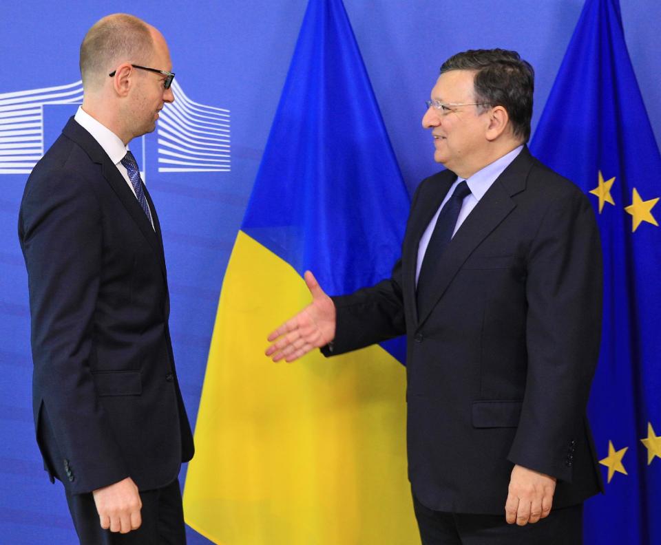 European Commission President Jose Manuel Barroso, right, welcomes Ukrainian Prime Minister Arseniy Yatsenyuk, at the European Commission headquarters in Brussels, Tuesday, May 13, 2014. The European Commission says it is determined to help Ukraine, and to make sure that Ukraine has all the support it needs, to undertake the political and economic reforms that are necessary for the country. (AP Photo/Yves Logghe)