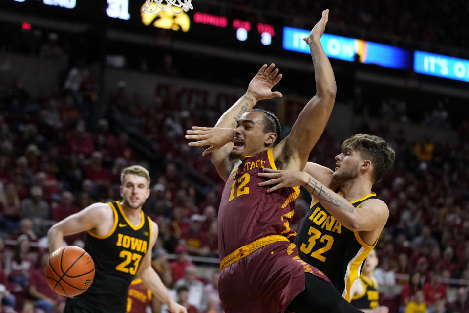 Iowa State forward Robert Jones (12) is fouled by Iowa forward Owen Freeman (32) during the second half of an NCAA college basketball game, Thursday, Dec. 7, 2023, in Ames, Iowa. (AP Photo/Charlie Neibergall)