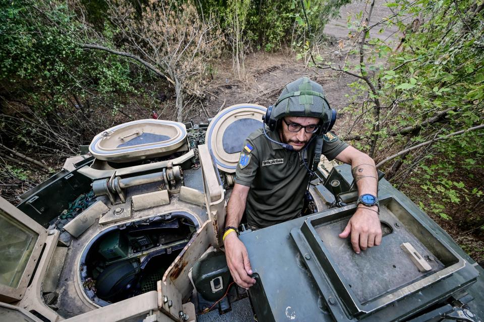 Gunner ‘Molfar’, 39, a Bradley IFV crew member of the 47th Magura Mechanized Brigade who took part in the fighting to liberate Robotyne village from Russian invaders, stands in the hatch of the vehicle in the southeastern Zaporizhzhia direction.