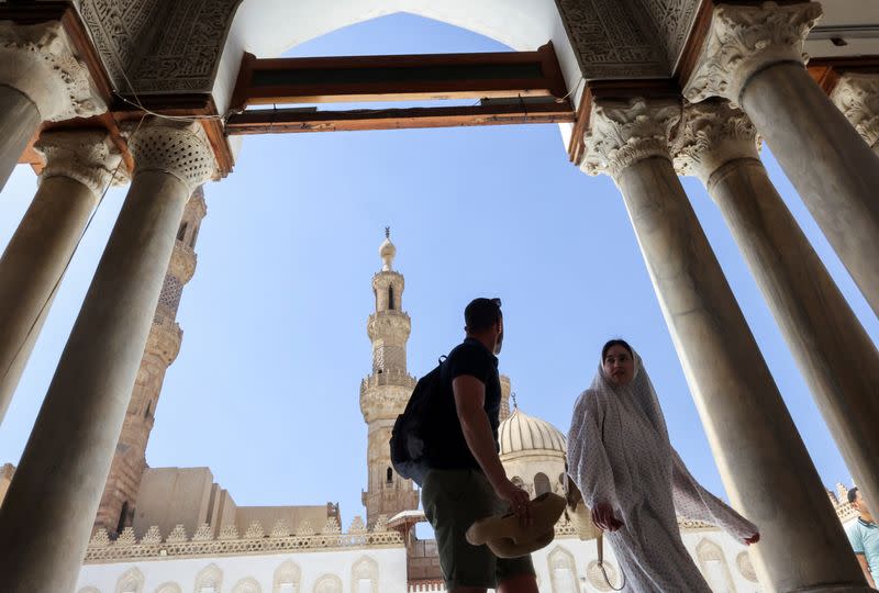 Foreign tourists walk at Al-Azhar Mosque during the Muslim holy month of Ramadan in Cairo