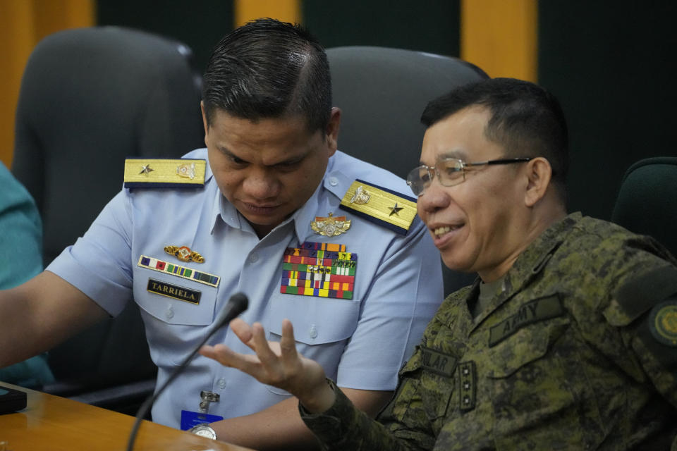 Philippine Coast Guard spokesperson, Commodore Jay Tarriela, left, talks with Armed Forces of the Philippines spokesperson Col. Medel Aguilar during a press conference on a recent incident with Chinese ships at the Second Thomas Shoal as they talk with reporters in Quezon City, Philippines on Monday, Oct. 23, 2023. A Chinese coast guard ship and an accompanying vessel rammed a Philippine coast guard ship and a military-run supply boat Sunday off a contested shoal, Philippine officials said, in an encounter that heightened fears of an armed conflict in the disputed South China Sea. (AP Photo/Aaron Favila)