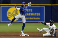 Toronto Blue Jays shortstop Bo Bichette forces Tampa Bay Rays' Manuel Margot, right, at second base and turns a double play on Kevin Kiermaier during the second inning of a baseball game Tuesday, Sept. 21, 2021, in St. Petersburg, Fla. (AP Photo/Chris O'Meara)