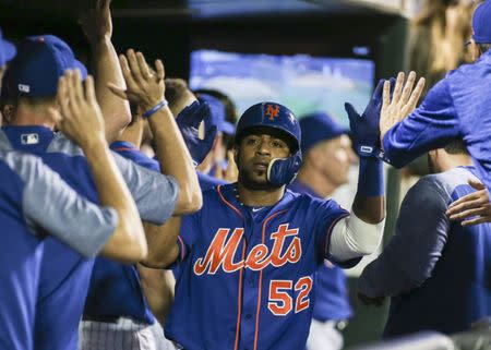 FILE PHOTO: May 4, 2018; New York City, NY, USA; New York Mets left fielder Yoenis Cespedes is congratulated in the dugout after scoring in the eighth inning against the Colorado Rockies at Citi Field. Mandatory Credit: Wendell Cruz-USA TODAY Sports