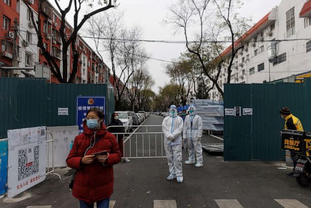 PHOTO: Epidemic-prevention workers in protective suits stand guard at a residential compound as outbreaks of coronavirus disease (COVID-19) continue in Beijinga, Nov. 28, 2022. (Thomas Peter/Reuters)