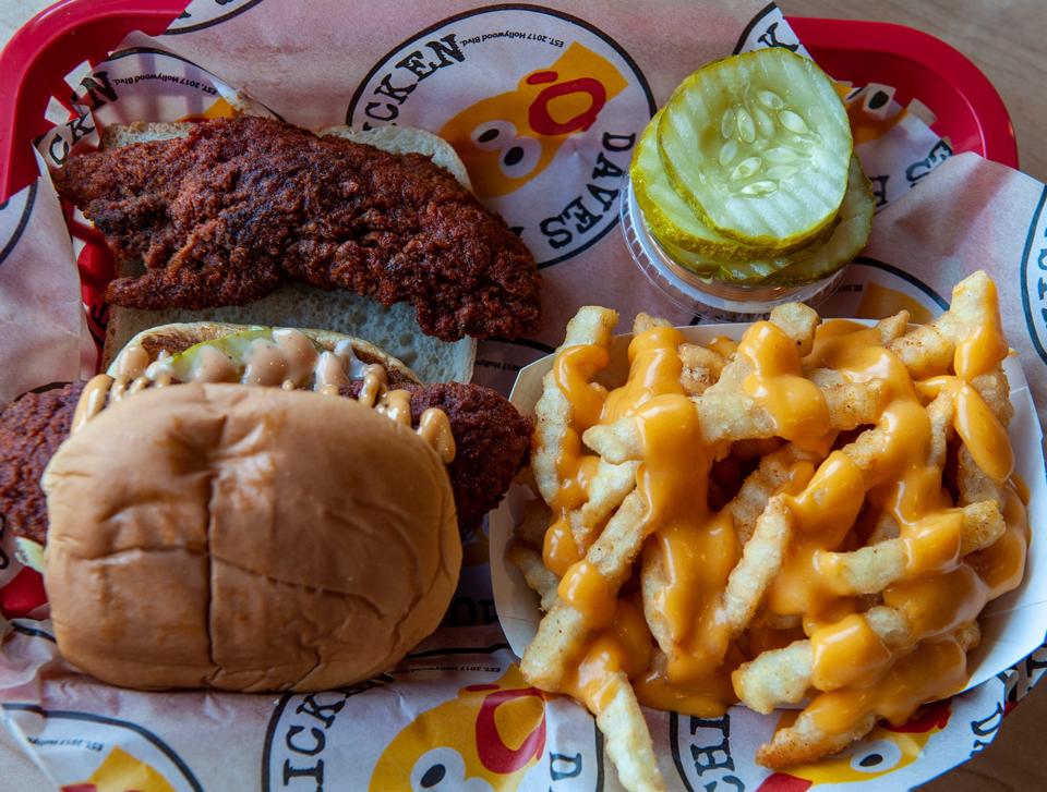 A plate of chicken tenders, a slider and cheesy fries at Dave's Hot Chicken, July 26, 2023. The restaurant is at 341 Cochitauate Road in Framingham.