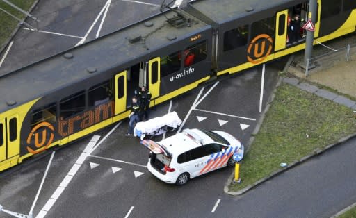 A body covered in a white sheet was seen near the tram after the shooting