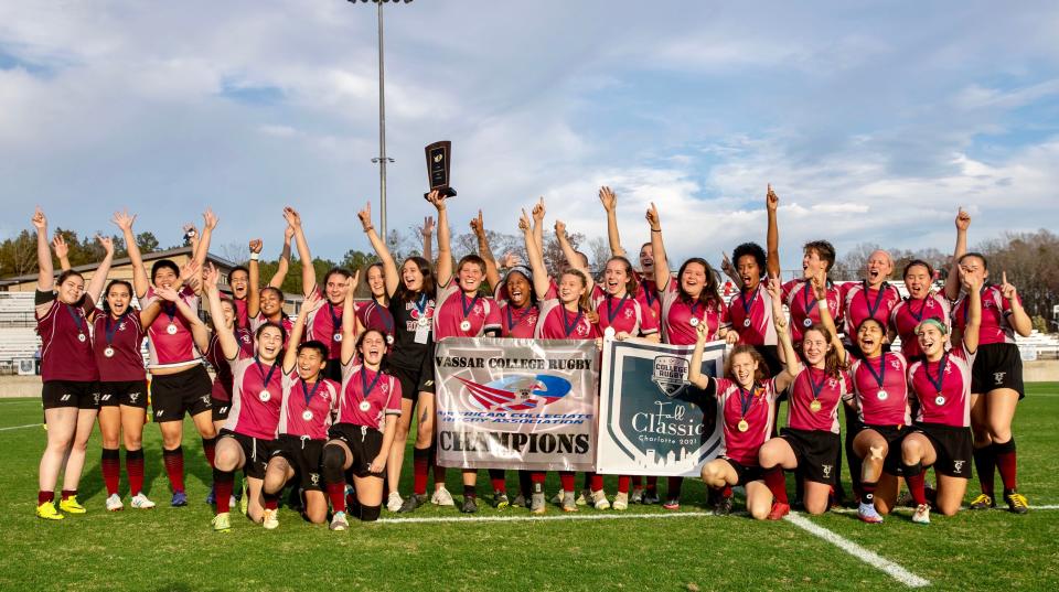 Members of the Vassar College women's rugby team raise their arms in celebration while posing for a photo after beating Temple in the American Collegiate Rugby Association Championship on Saturday.