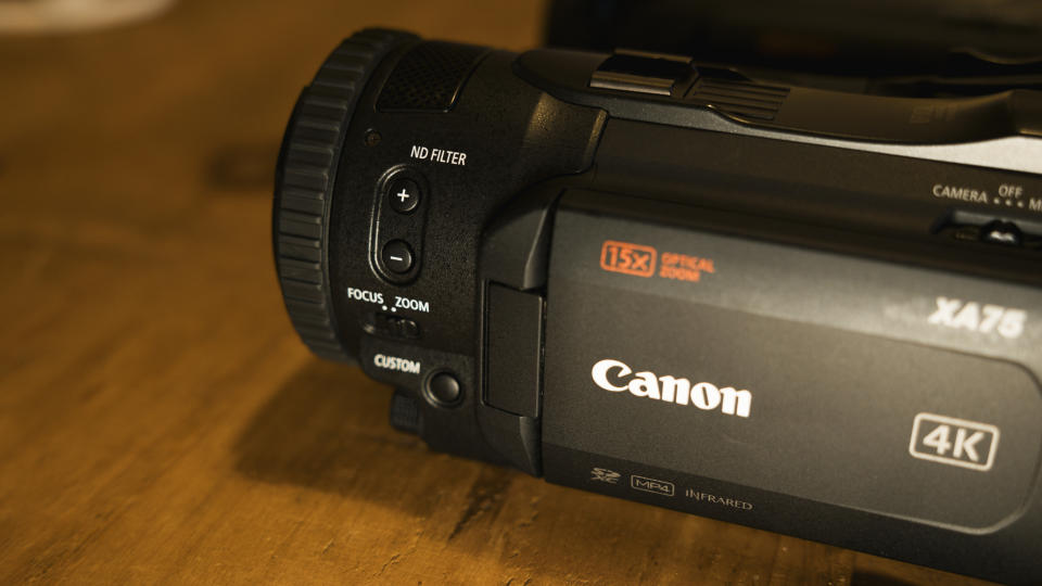 The Canon XA75 camcorder on a wooden table