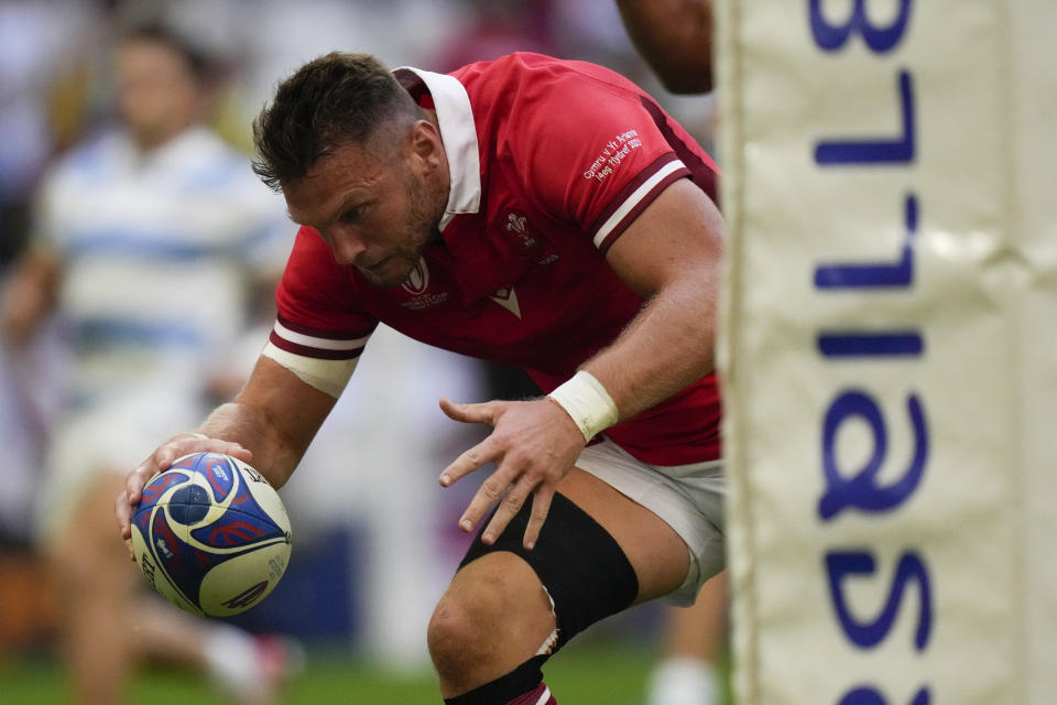 Wales' Dan Biggar scores the opening try during the Rugby World Cup quarterfinal match between Wales and Argentina at the Stade de Marseille in Marseille, France, Saturday, Oct. 14, 2023. (AP Photo/Pavel Golovkin)