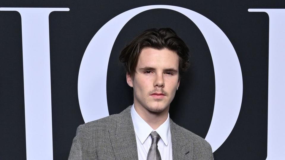 cruz beckham stopping for a photocall at a paris fashion event