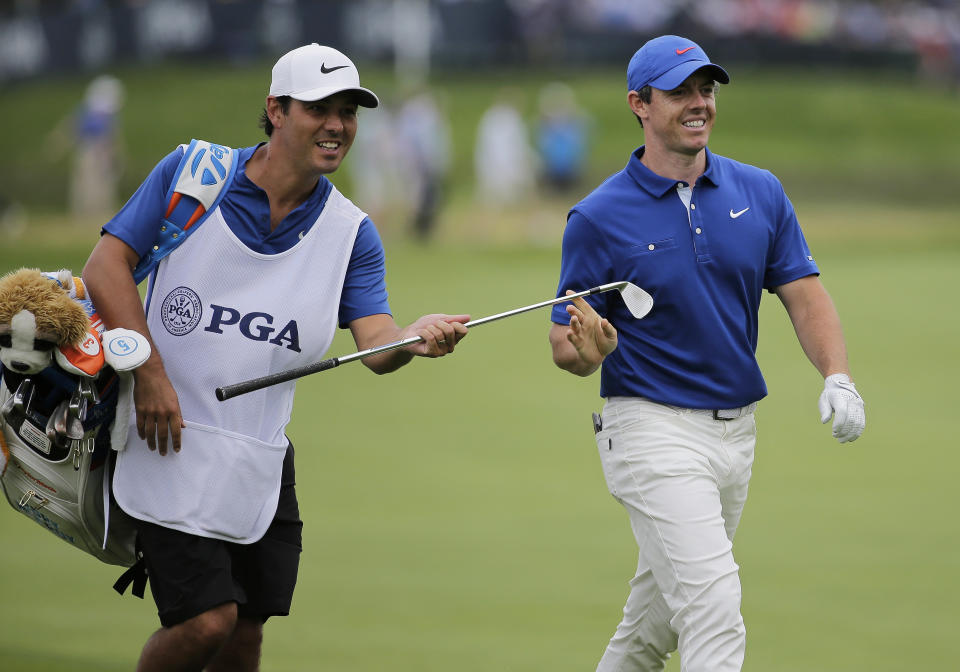 Rory McIlroy, of Northern Ireland, hands an iron to his caddie on the 15th fairway during the final round of the PGA Championship golf tournament, Sunday, May 19, 2019, at Bethpage Black in Farmingdale, N.Y. (AP Photo/Seth Wenig)