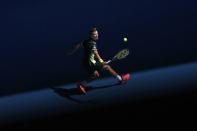 Tennis - Australian Open - Rod Laver Arena, Melbourne, Australia, January 22, 2018. Marton Fucsovics of Hungary hits a shot against Roger Federer of Switzerland. REUTERS/Edgar Su