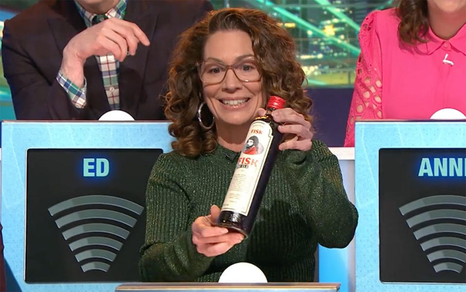 Kitty Flanagan holding up Fisk Liquor