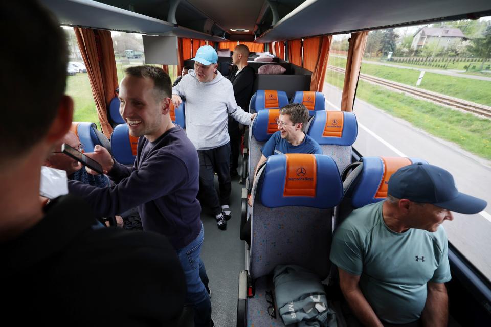 Participants talk and laugh during the bus ride in Poland toward Ukraine as part of a Utah delegation trip on Sunday, April 30, 2023. | Scott G Winterton, Deseret News