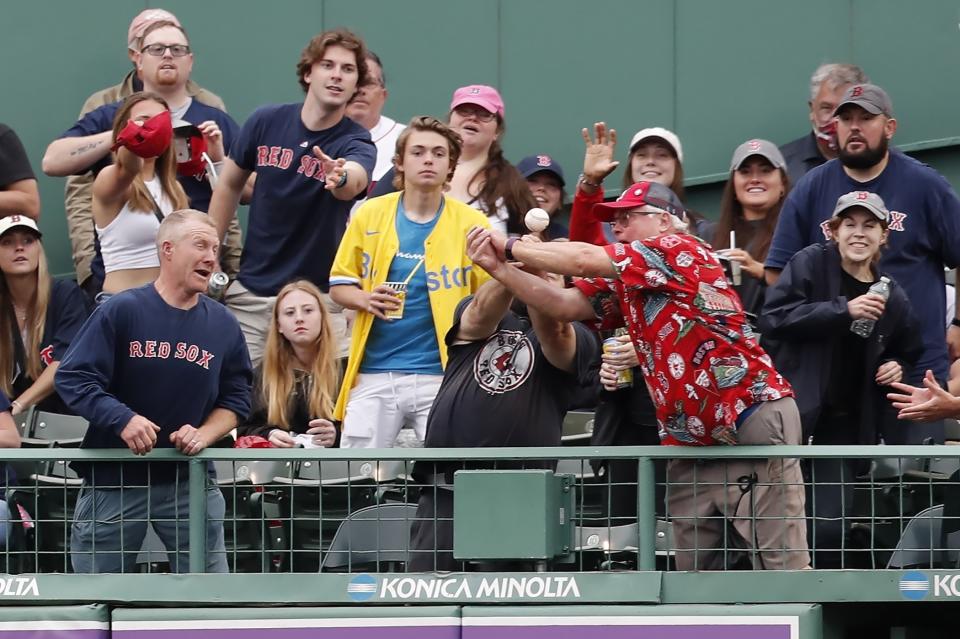 Fans try to catch a three-run home run by Baltimore Orioles' Rougned Odor during the third inning of the second game of a baseball doubleheader, against the Boston Red Sox, Saturday, May 28, 2022, in Boston. (AP Photo/Michael Dwyer)