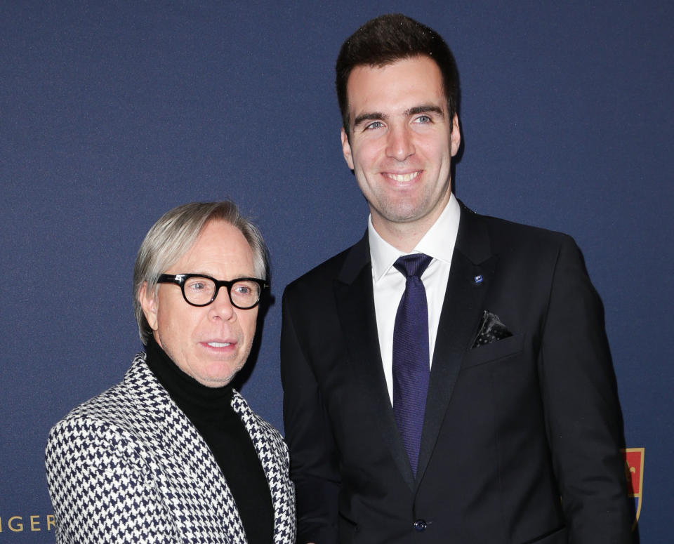 This image released by Starpix shows designer Tommy Hilfiger, left, with Baltimore Ravens quarterback Joe Flacco at the Tommy Hilfiger Men's Fall 2013 collection, Friday, Feb. 8, 2013 during Fashion Week in New York. (AP Photo/Starpix, Andrew Toth)