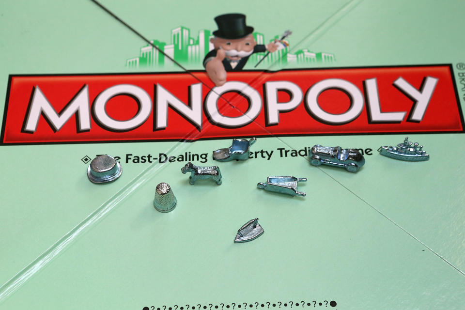 FAIRFAX, CA - FEBRUARY 06:  In this photo illustration, Monopoly game pieces are displayed on February 6, 2013 in Fairfax, California. Toy maker Hasbro, Inc. announced today that fans of the board game Monopoly voted in an online contest to eliminate the iron playing figure and replace it with a cat figure. The cat game piece received 31 percent of the online votes to beat out four other contenders, a robot, diamond ring, helicopter and guitar.  (Photo illustration by Justin Sullivan/Getty Images)