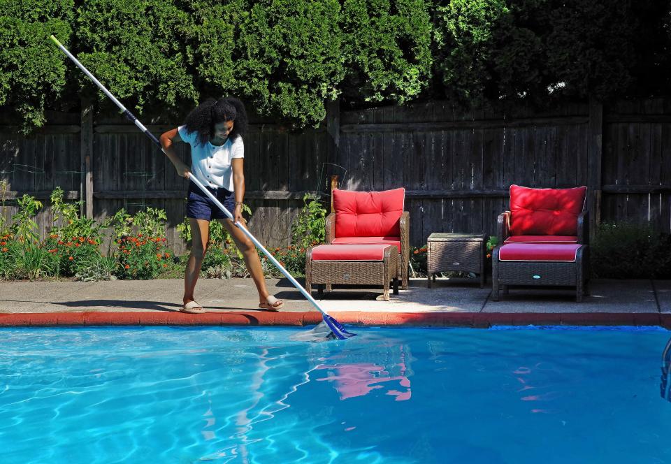 Solmaz Celik McDowell, of Brockton, gets her pool ready for her Swimply customers on Wednesday, Aug. 3, 2022. The pool uses salt water which McDowell says produces a natural chlorine substance to help maintain quality.