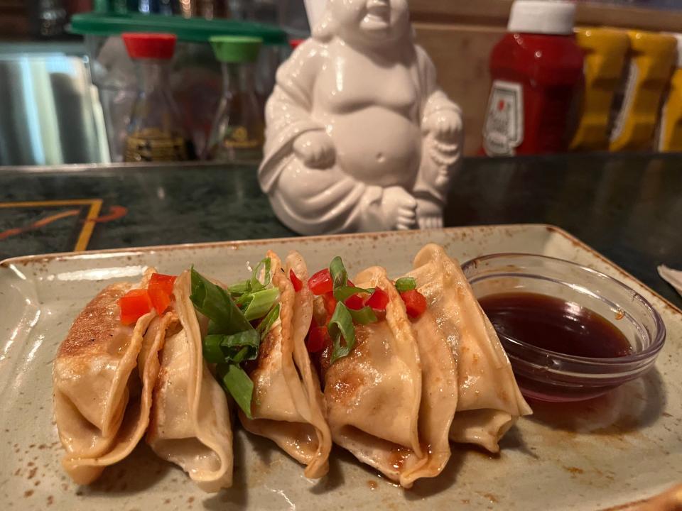 pot stickers on a plate with dipping sauce from yak and yeti restaurant in animal kingdom