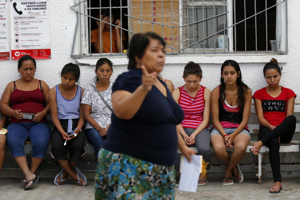 In this July 29, 2019, photo, Marta Alicia Esquivel, a volunteer at El Buen Pastor shelter for migrants, center, scolds a group of migrant mothers about the care of their children and asks for more help with cleaning at the shelter in Cuidad Juarez, Mexico. (AP Photo/Gregory Bull)