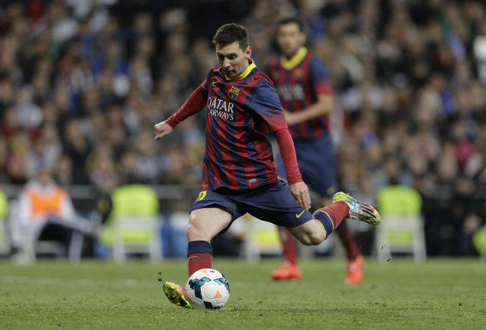 FC Barcelona's Lionel Messi from Argentina scores a penalty during a Spanish La Liga soccer match against Real Madrid, at the Santiago Bernabeu stadium in Madrid, Sunday March 23, 2014. (AP Photo/Paul White)